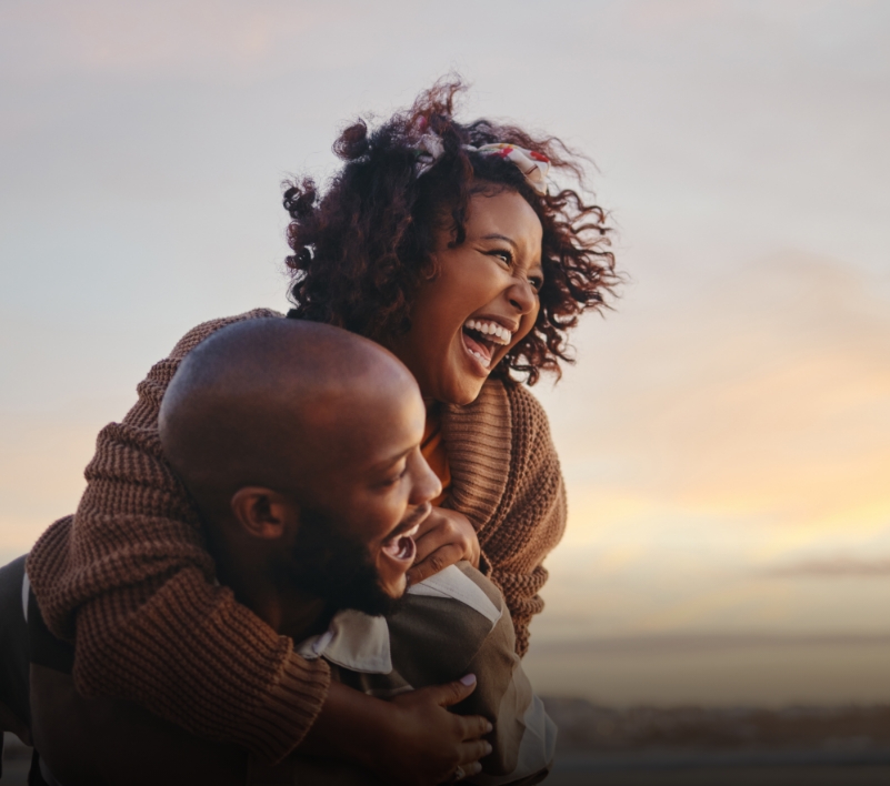 Couple laughing at sunset